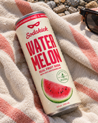 A Sodakick Watermelon can on a beach towel