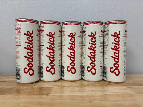 The Sodakick script side of the five sample cans