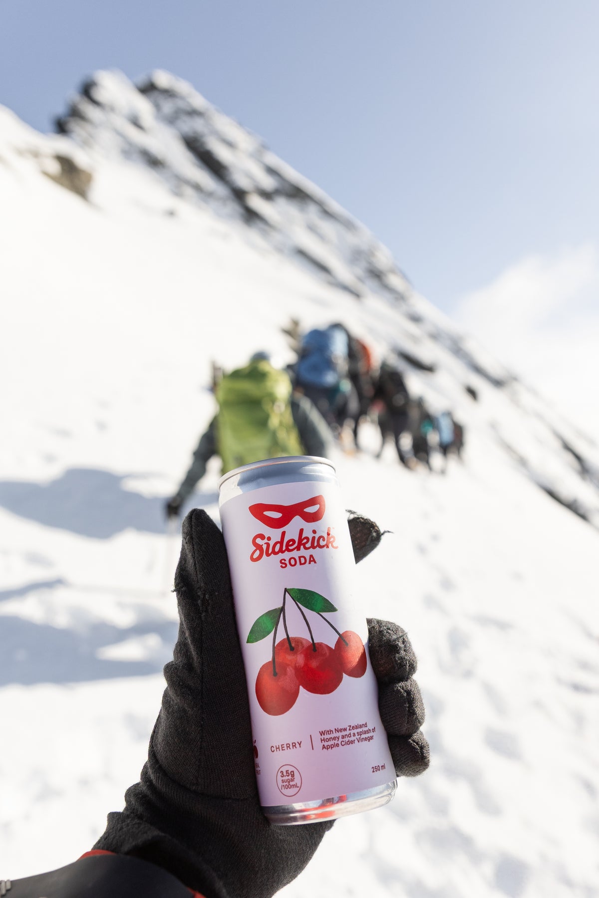 Sidekick can held outdoors at a New Zealand mountain festival — lifestyle photography