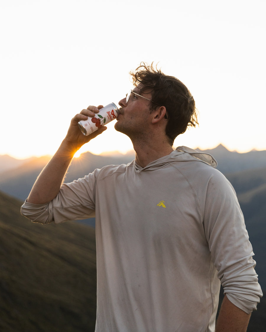 Drinking Sidekick Cherry on a New Zealand mountain ridge at sunset