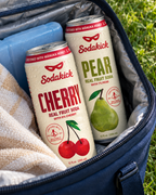 Sodakick Cherry and Pear in a navy cooler, ready to take out