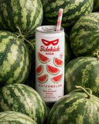 Chilled Sidekick Watermelon can with striped straw nestled among whole watermelons